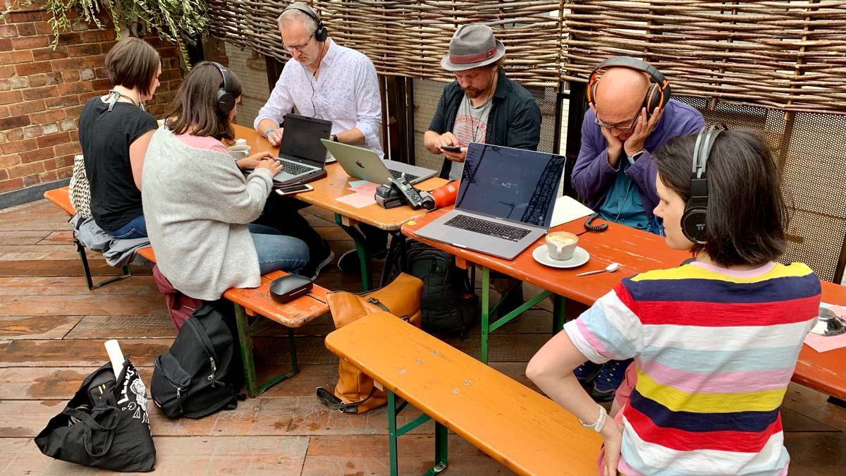 A group of people listening to audio recordings together.